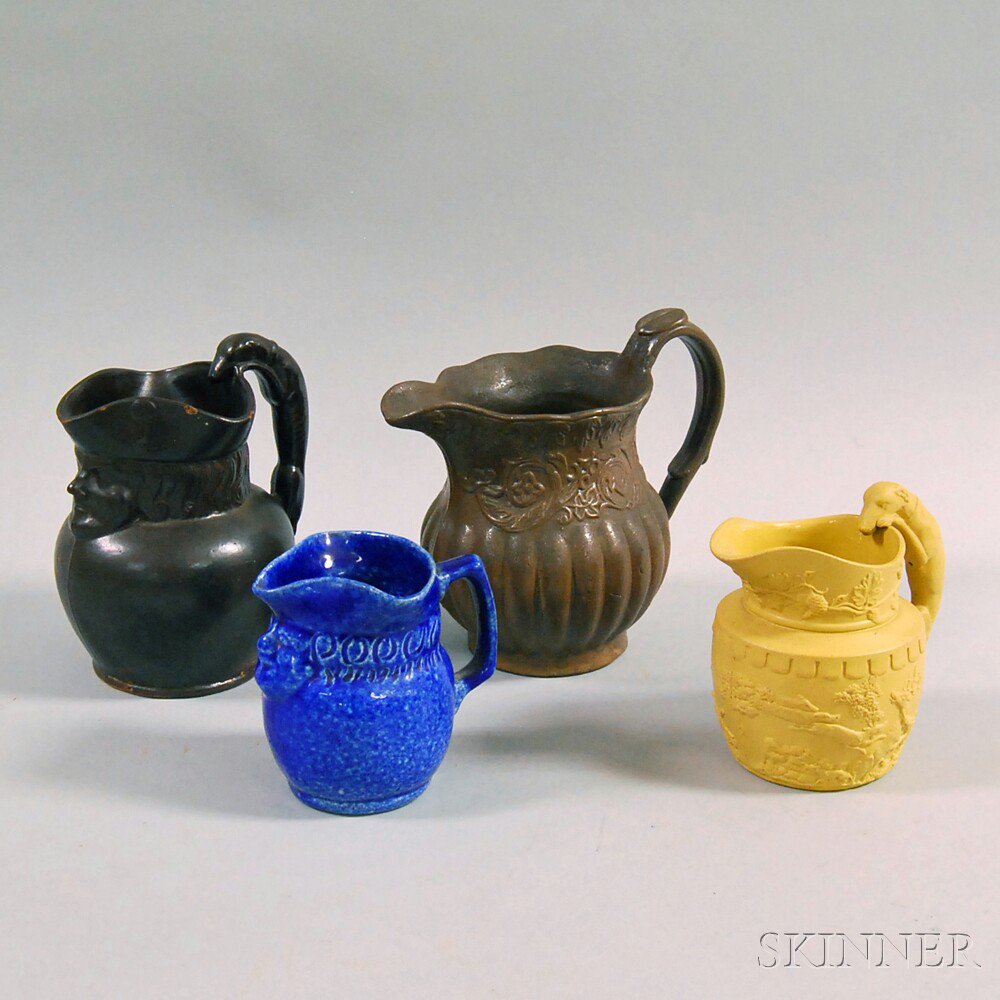 Appraisal: Four Stoneware Jugs a blue-glazed Poillon Pottery toby jug a