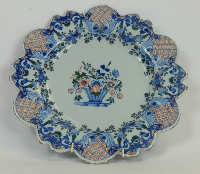 Appraisal: Early Delft shaped tin glaze plate decorated with flowers diameter