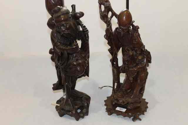 Appraisal: A CARVED CHINESE HARDWOOD MODEL of an Immortal with star