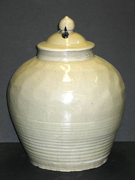 Appraisal: An ivory glazed pottery covered storage jar With faceted walls