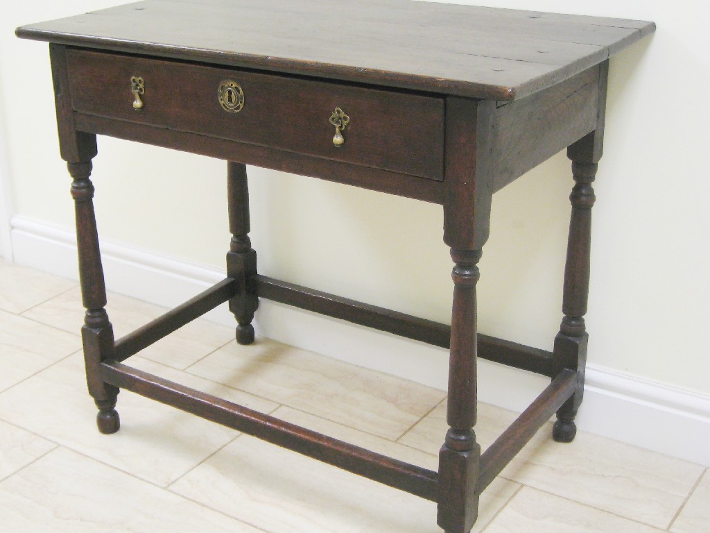 Appraisal: An th Century oak Lowboy fitted frieze drawer on turned