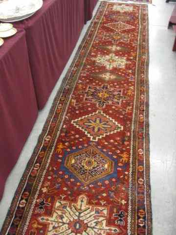 Appraisal: Heriz Persian Handmade Runner elaborate geometric medallions red field '