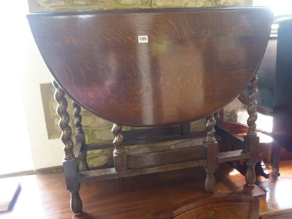 Appraisal: A 's oak oval drop leaf gateleg dining table raised