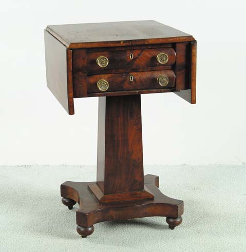 Appraisal: TWO DRAWER DROP LEAF MAHOGANY EMPIRE STAND Brass knobs to