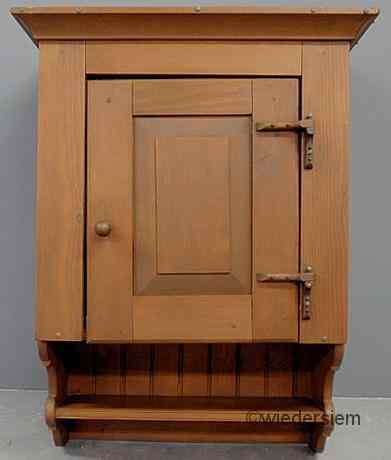 Appraisal: Pine hanging cupboard th c with raised panel door and