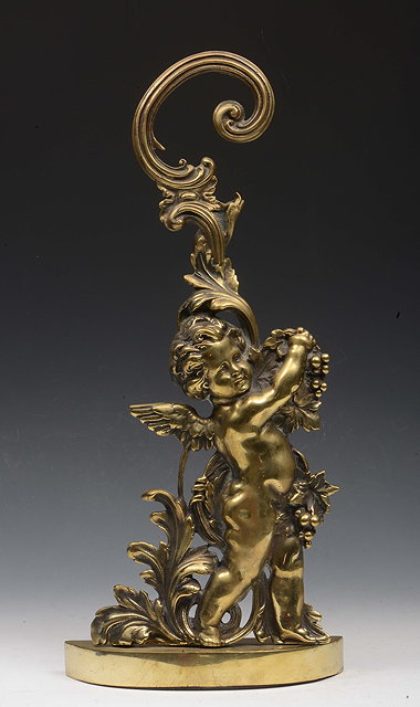 Appraisal: A HEAVY BRASS DOOR STOP in the form a cherub