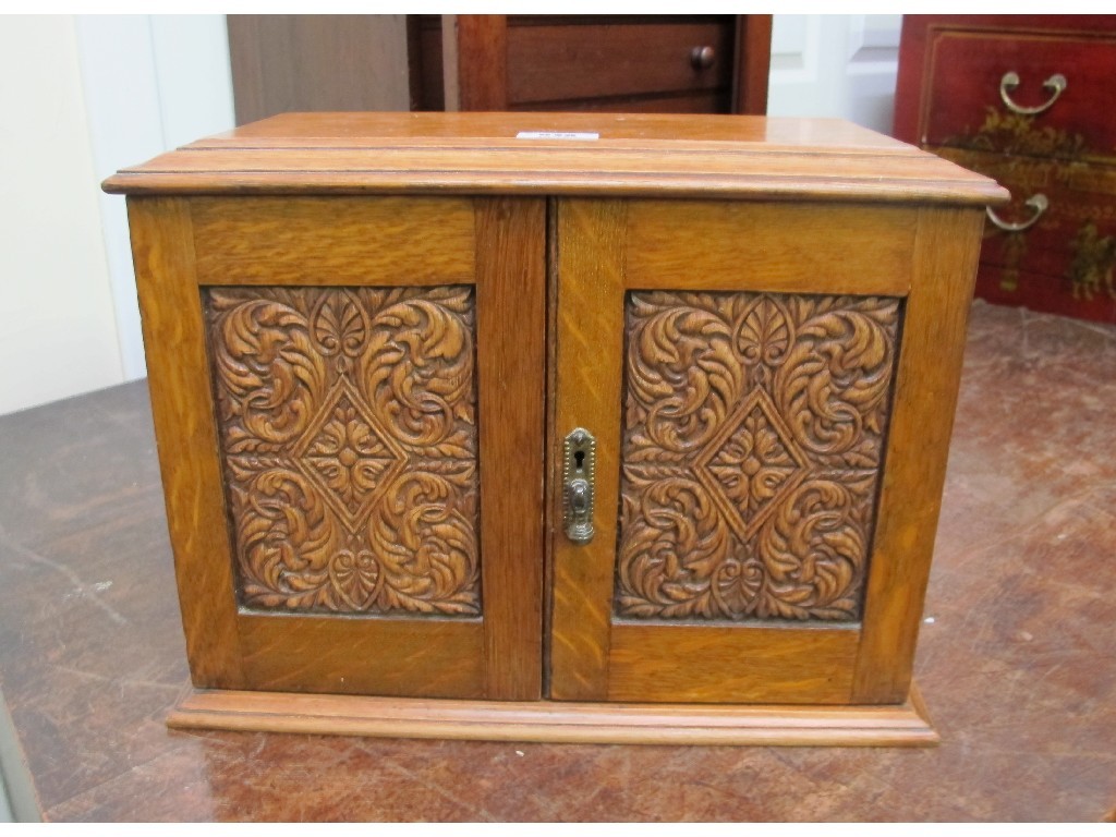 Appraisal: Carved oak smokers cabinet