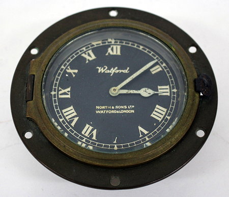 Appraisal: A WATFORD BRASS CASED CAR CLOCK the black dial with