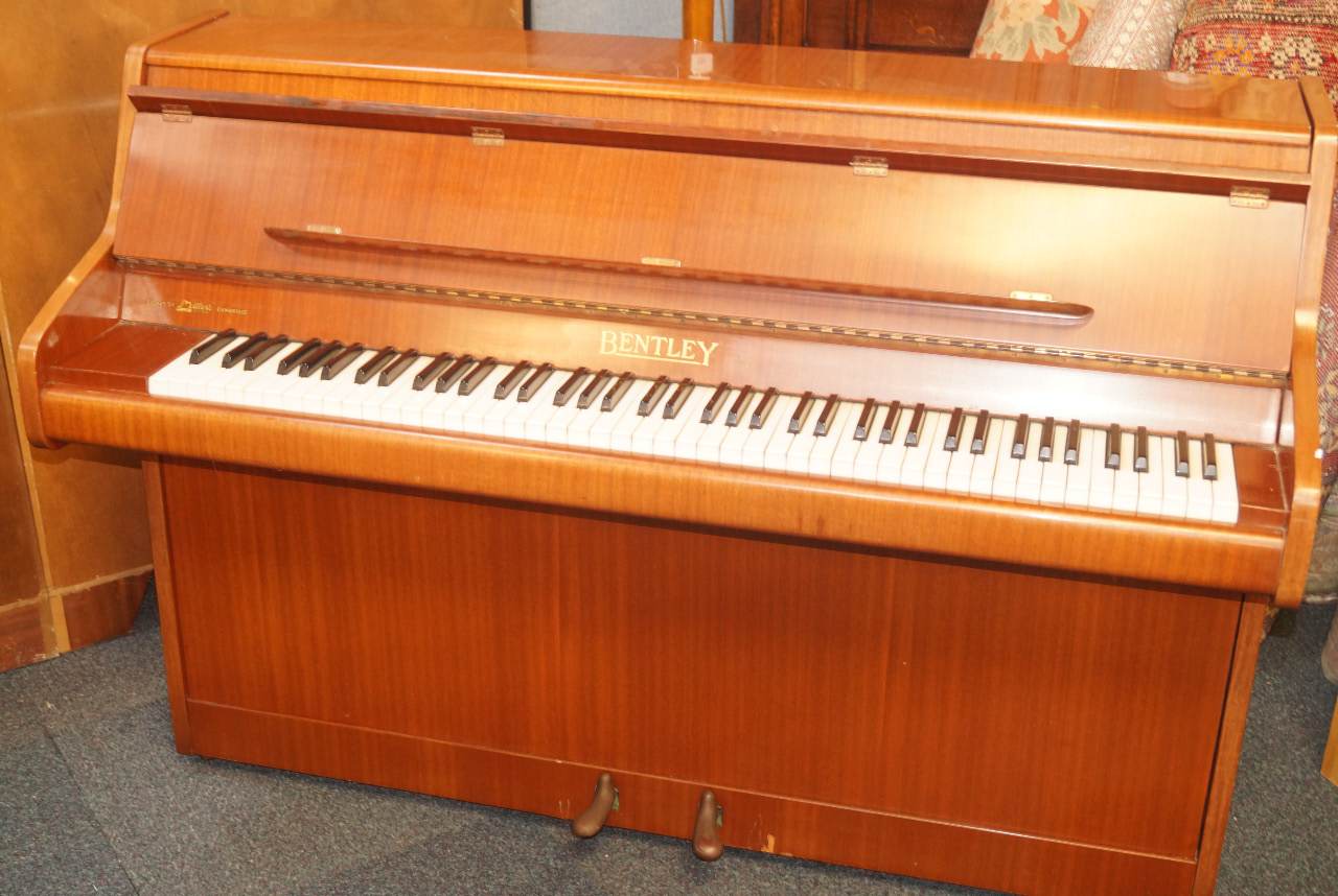 Appraisal: A mahogany cased piano by Bentley with gilt pedals etc