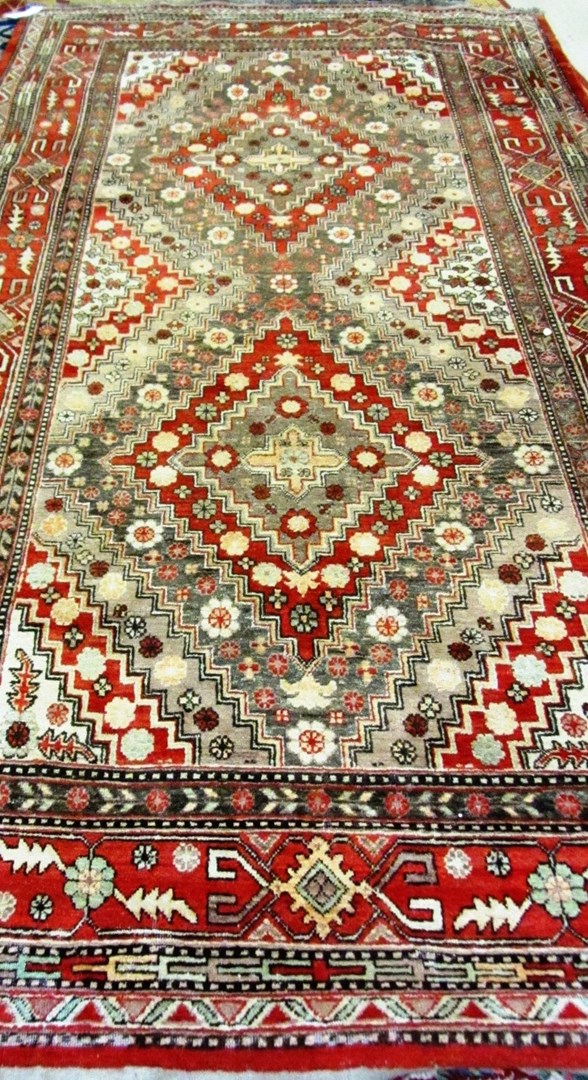 Appraisal: A Khotan carpet the field with diminishing diamond design with