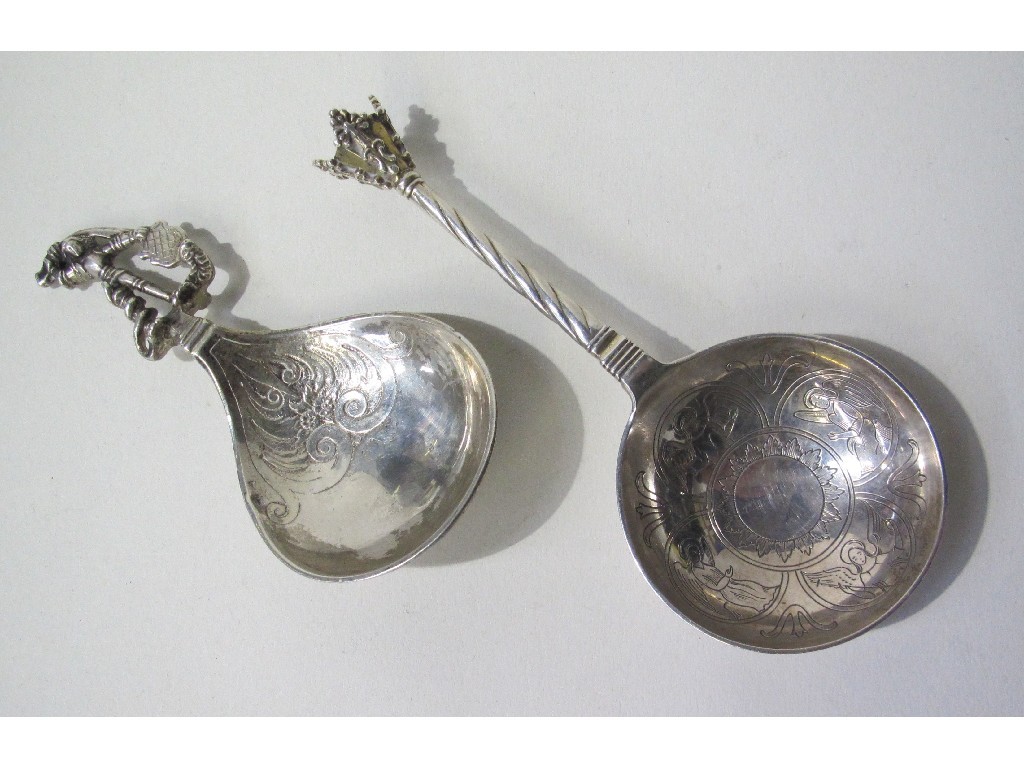 Appraisal: Lot comprising two continental white metal serving spoons with ornate