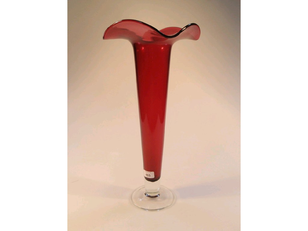 Appraisal: A cased cranberry glass lily vase with an undulating everted