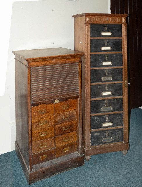 Appraisal: AN EDWARDIAN OAK FILING CABINET fitted sixteen drawers and with