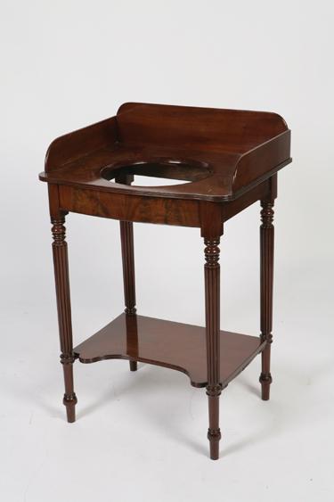 Appraisal: A REGENCY MAHOGANY WASHSTAND the shaped top with a central