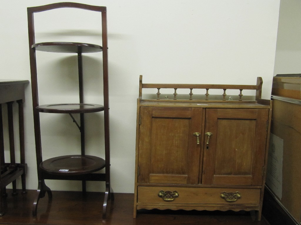 Appraisal: Mahogany folding cakestand and a mahogany wall mounting cupboard