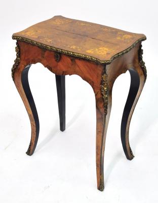 Appraisal: A WALNUT AND KINGWOOD WORK TABLE of serpentine oblong form