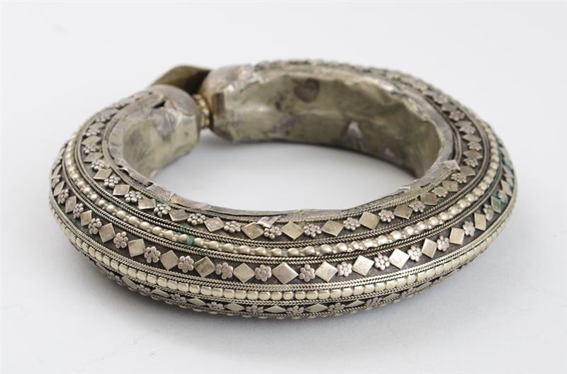 Appraisal: ETHNOGRAPHIC HOLLOW SILVERED-METAL BRACELET With diamond and flowerhead bands and