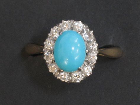 Appraisal: A TURQUOISE AND DIAMOND CLUSTER RING the central oval cabochon