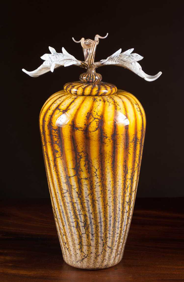 Appraisal: GARTNER BLADE ART GLASS LIDDED VASE Batik with Avian finial