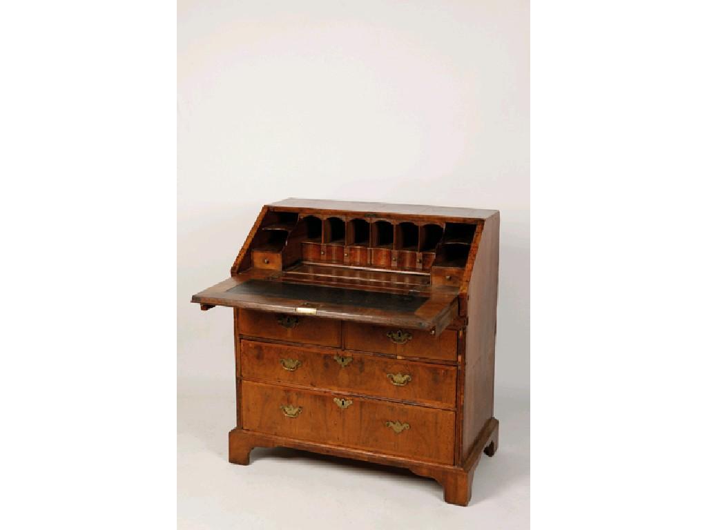 Appraisal: A GEORGE I WALNUT AND FEATHER BANDED BUREAU the sloping