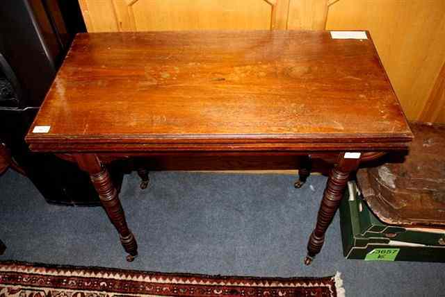 Appraisal: A VICTORIAN MAHOGANY CARD TABLE with red felt top on