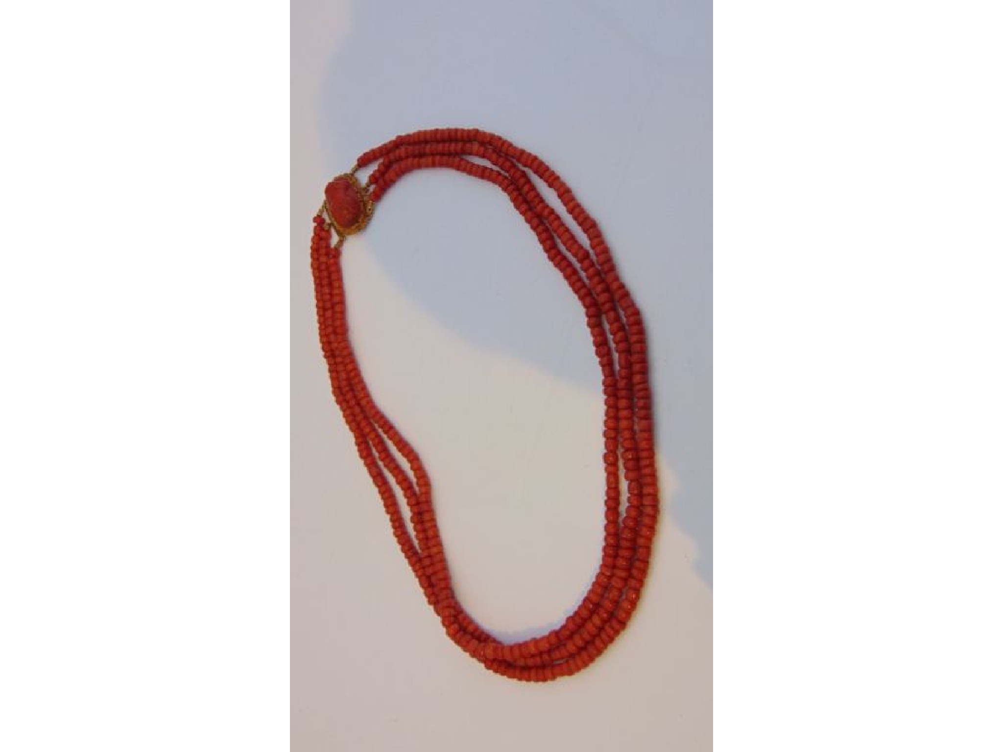 Appraisal: A th century triple strand coral necklace the clasp set