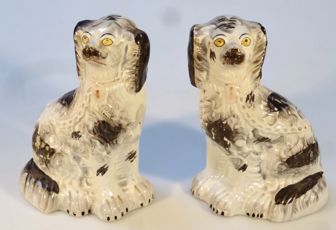 Appraisal: A pair of thC Staffordshire spaniels each with textured bodies