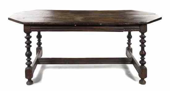 Appraisal: An English Trestle Table having a rectangular top with canted