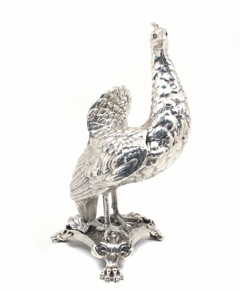 Appraisal: A plated figure of a peacock Depicted standing on a