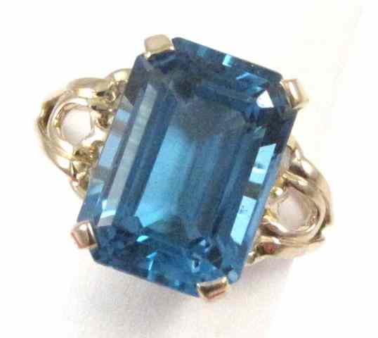 Appraisal: BLUE TOPAZ AND FOURTEEN KARAT GOLD RING set with an