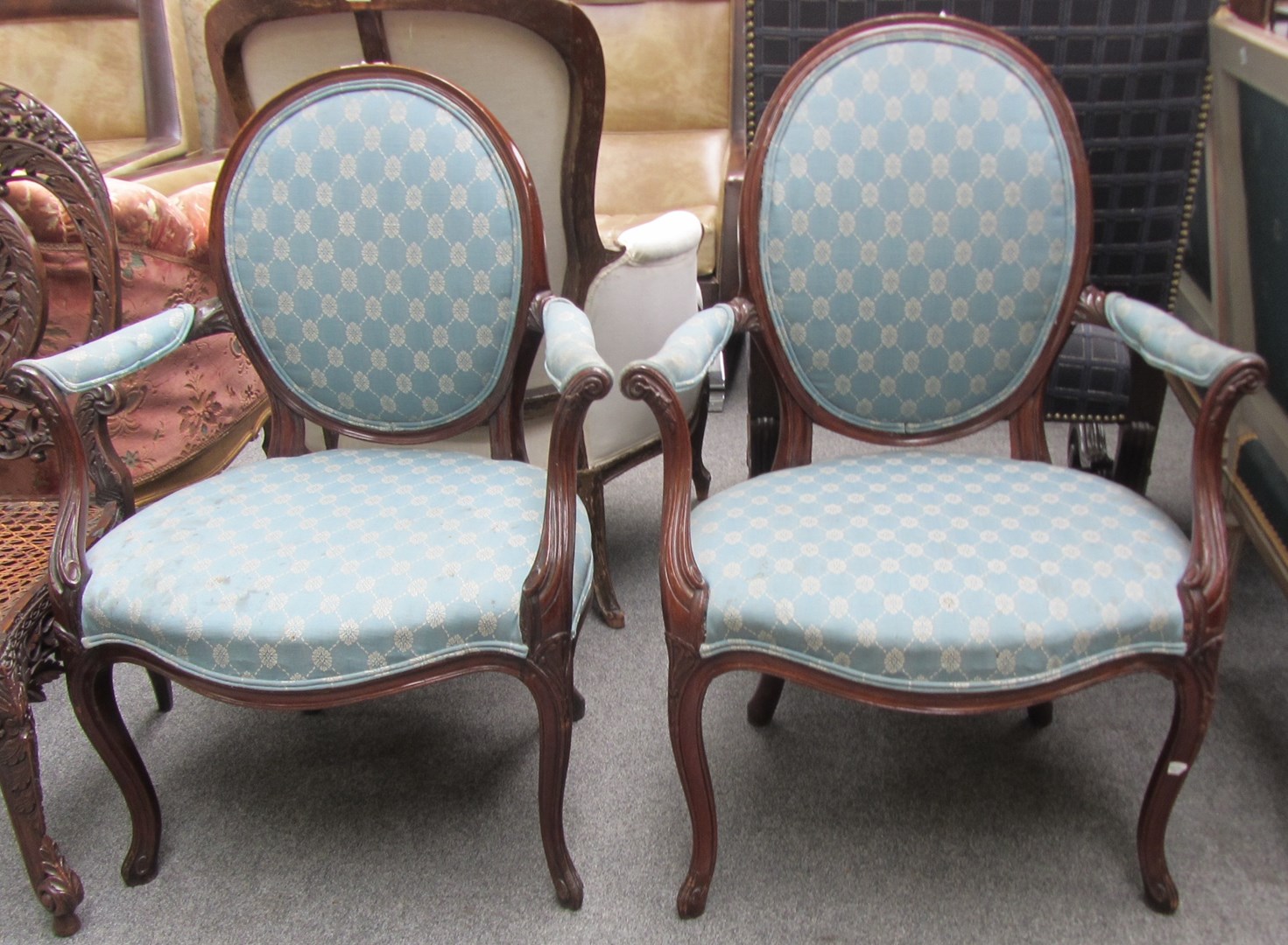 Appraisal: A pair of th century French carved mahogany framed fauteuils