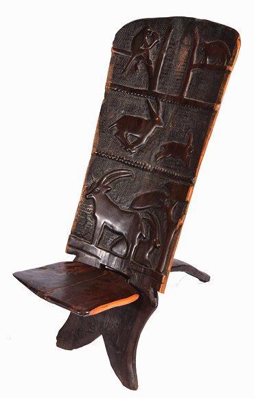 Appraisal: AN AFRICAN CARVED HARDWOOD CHAIR the upright back carved with