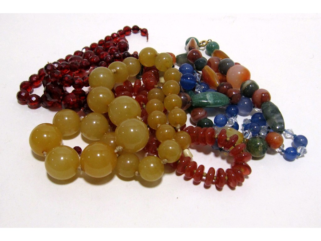 Appraisal: Lot comprising cornelian beads Scottish pebble beads faceted red beads