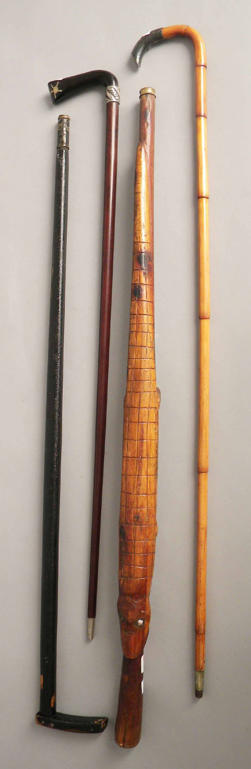 Appraisal: Four canes including one with an alligator carving and another