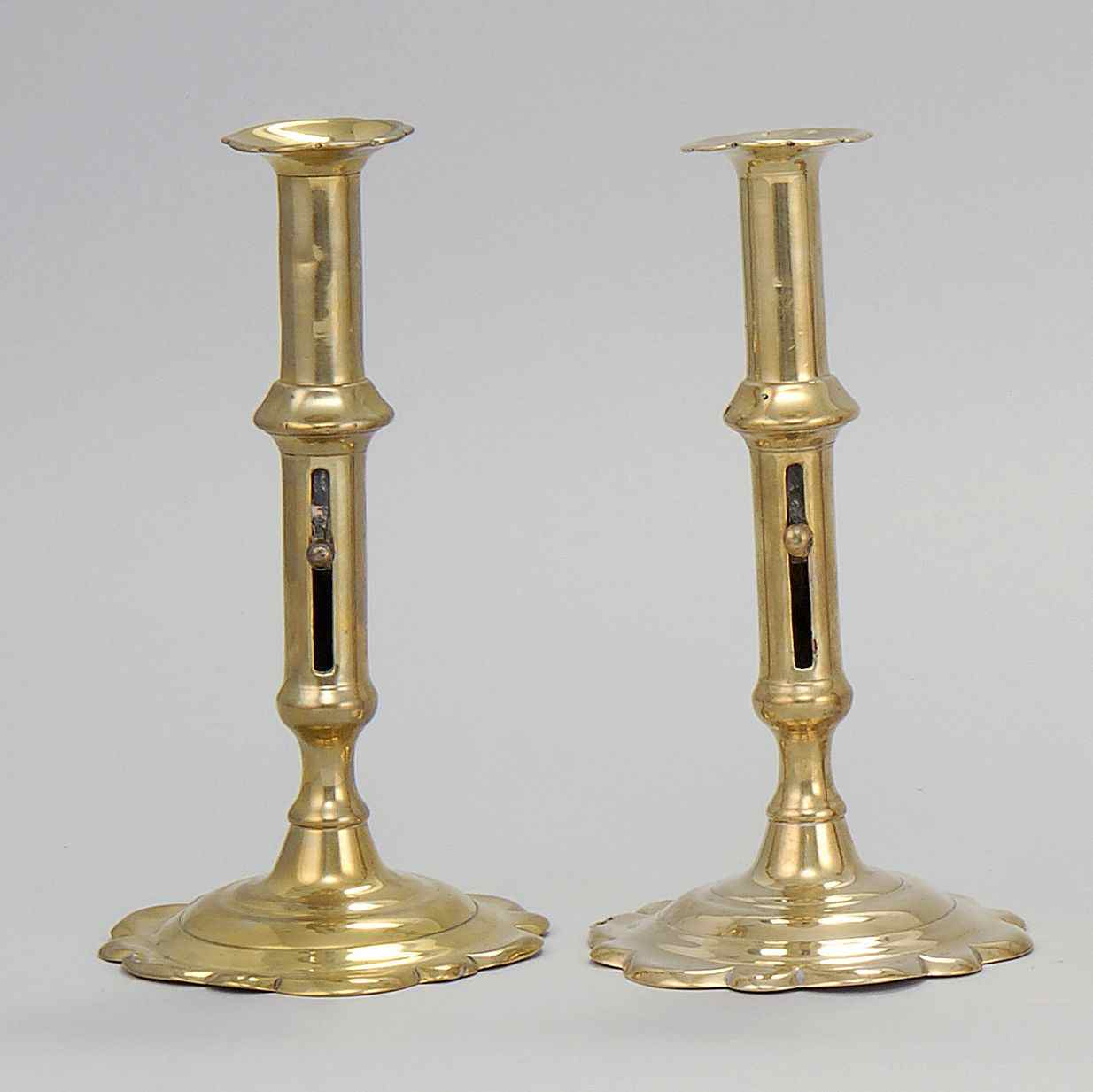 Appraisal: PAIR OF QUEEN ANNE GEORGE II PETAL-BASE CANDLESTICKSMid- th CenturyWith