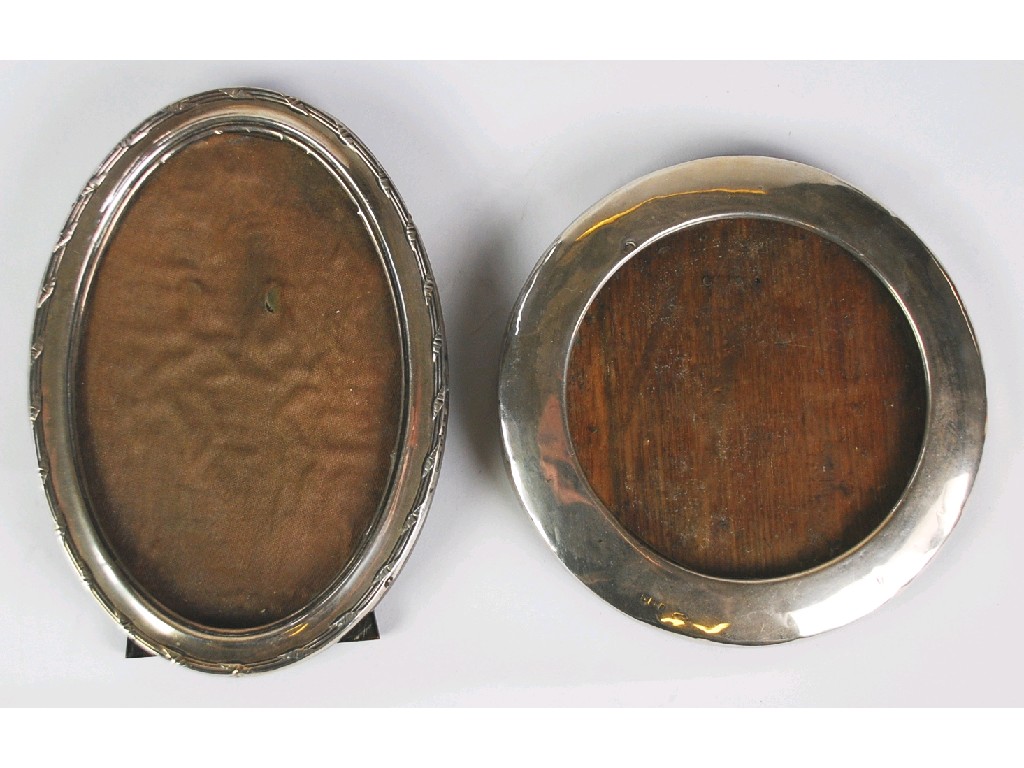 Appraisal: TWO GEORGE V SILVER PHOTOGRAPH FRAMES one oval with reeded