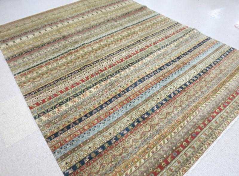 Appraisal: A CONTEMPORARY HAND KNOTTED ORIENTAL CARPET repeating color stripe design