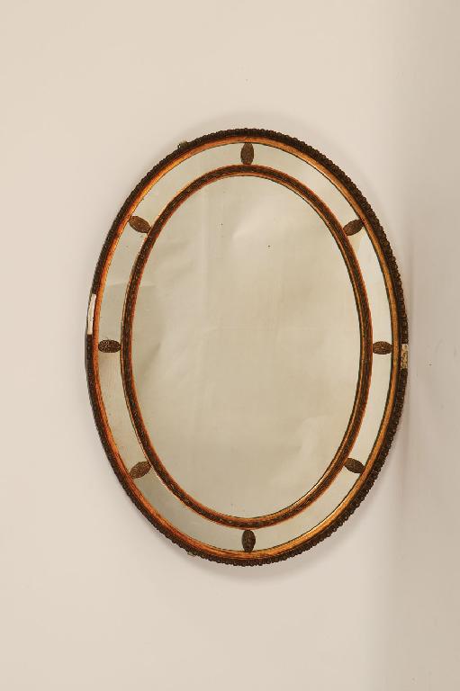 Appraisal: A GEORGE III STYLE NINE PLATE OVAL MIRROR with a