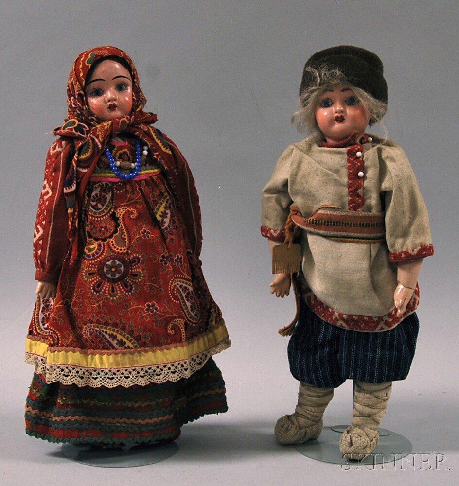 Appraisal: Two Papier-mache Dolls a pink-toned boy in cotton and linen