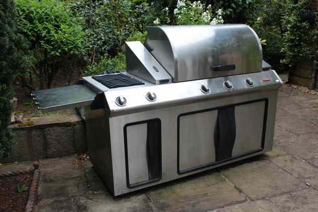 Appraisal: A LARGE BENSON STAINLESS STEEL BARBECUE with gas fired grill