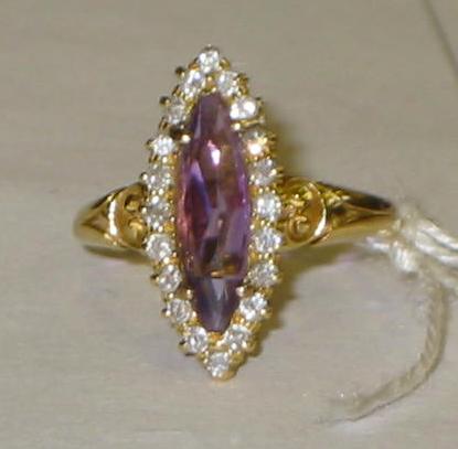 Appraisal: A MARQUISE RING with single amethyst surrounded by twenty eight