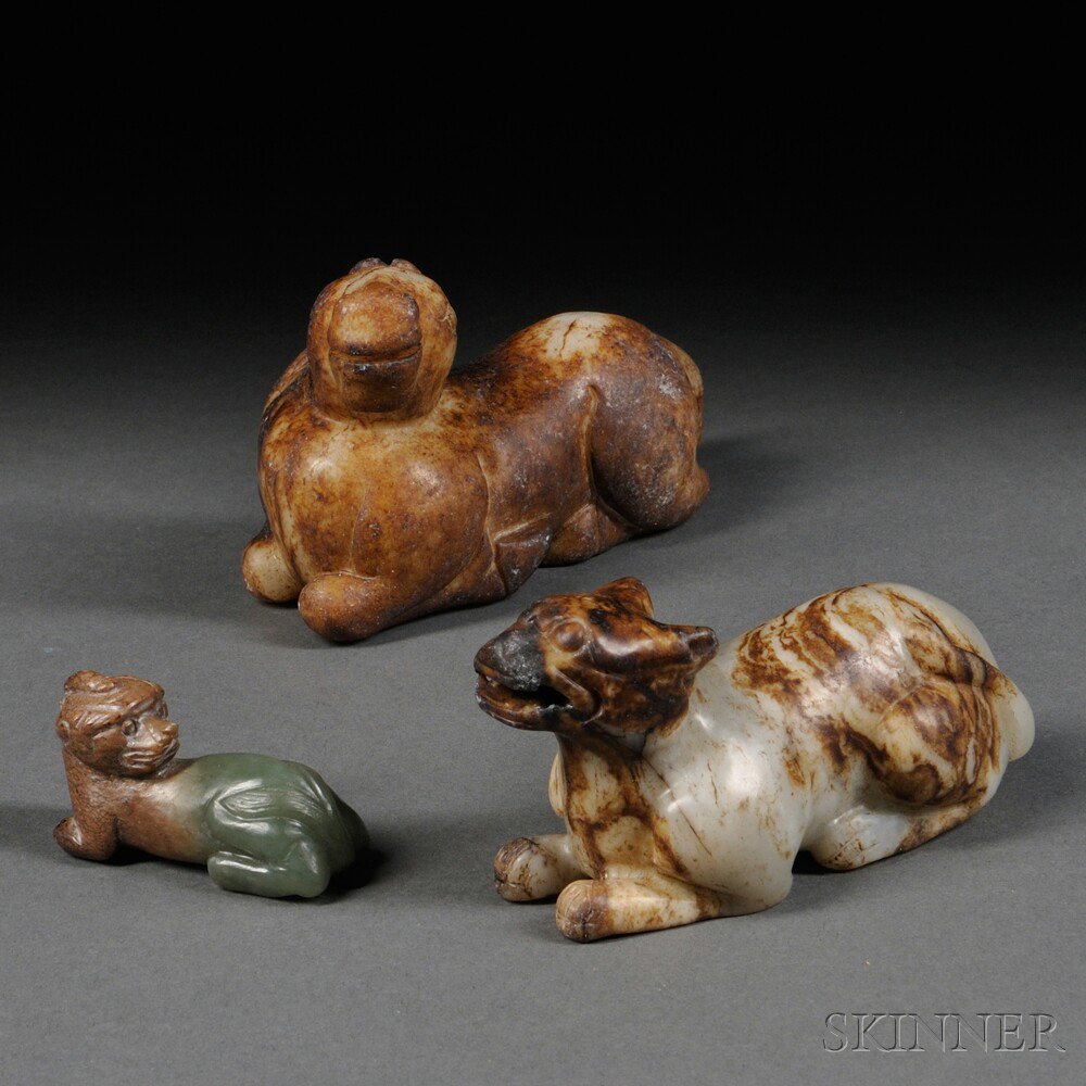 Appraisal: Three Stone Carvings of Seated Animals China a horse of