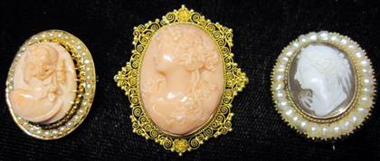 Appraisal: Three yellow gold cameosOne karat coral with seed pearl frame