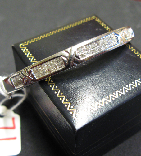 Appraisal: DIAMOND AND FOURTEEN KARAT WHITE GOLD BANGLE set with princess-cut