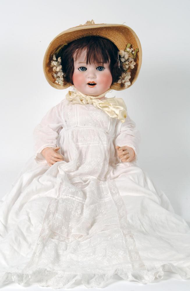 Appraisal: An Ernst Heubach bisque head girl doll with blue glass