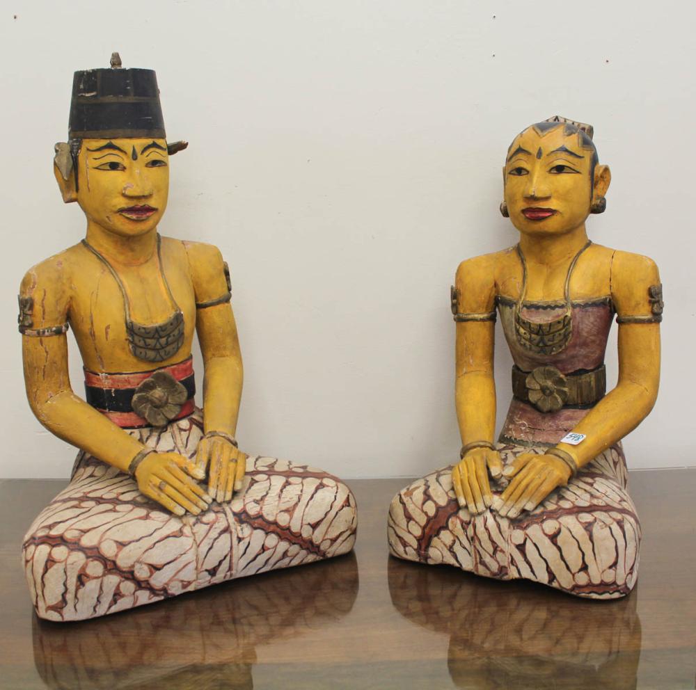 Appraisal: TWO CARVED AND PAINTED WOOD INDONESIAN FIGURES male and female