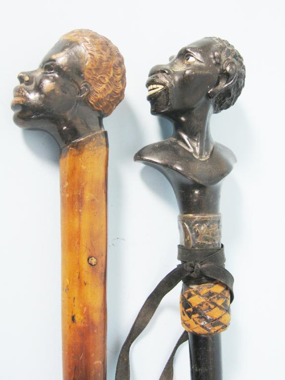 Appraisal: Two Walking Sticks the handles carved as African Busts inset