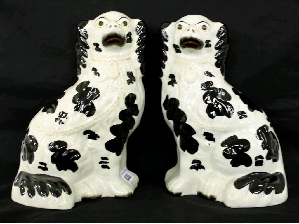 Appraisal: Pair of Staffordshire seated spaniels with rough coats and black