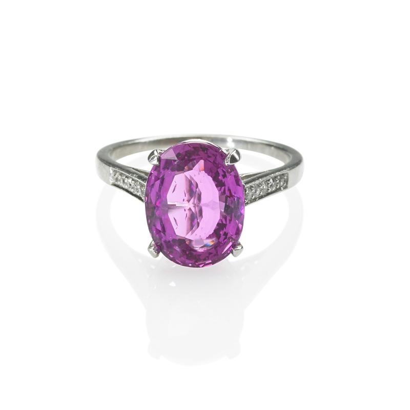 Appraisal: PINK SAPPHIRE PLATINUM DIAMOND RING Oval faceted pink sapphire approx