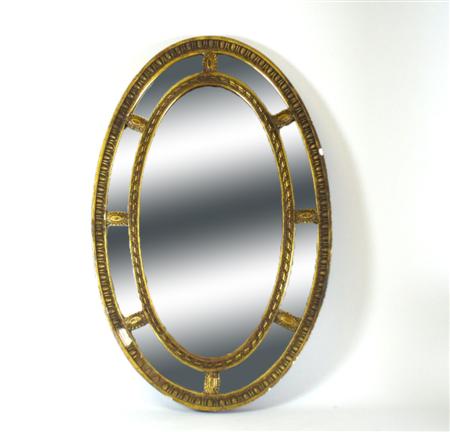 Appraisal: A th century giltwood mirror the oval mirror surrounded by